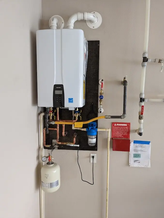 Professional plumber installing copper piping in a Hopewell home